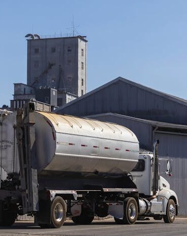 Photo by Robert So: https://www.pexels.com/photo/tanker-for-transporting-grain-feed-in-front-of-warehouses-18468412/